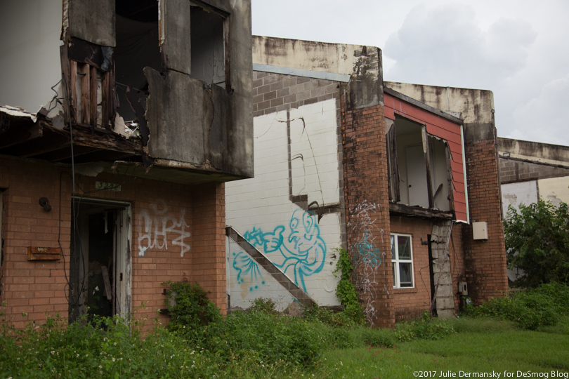 Damaged homes marked with graffiti in New Orleans' Press Park housing project