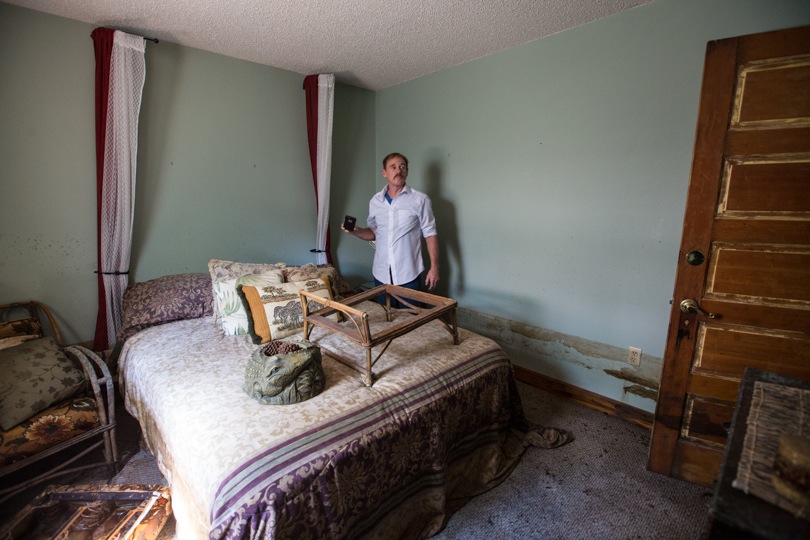 Frank Bonifay checks out the damage in his flooded house. 