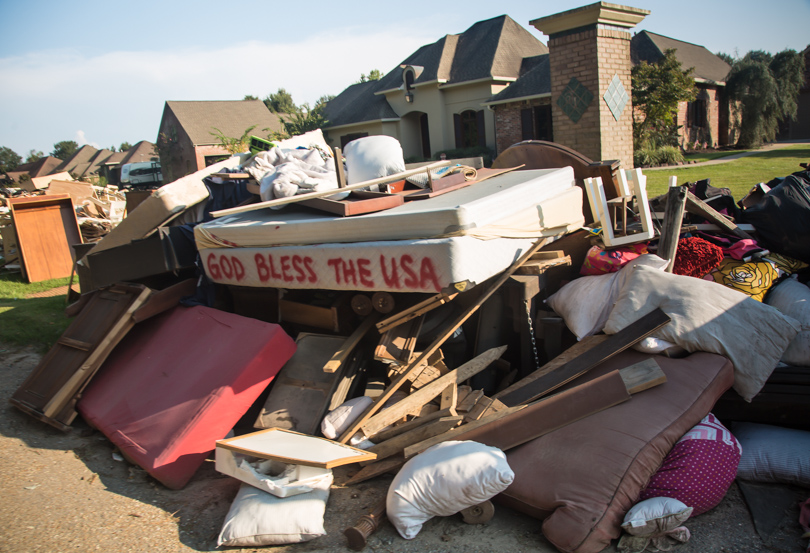 Piles of contents from flooded homes in Walker lining the street. 