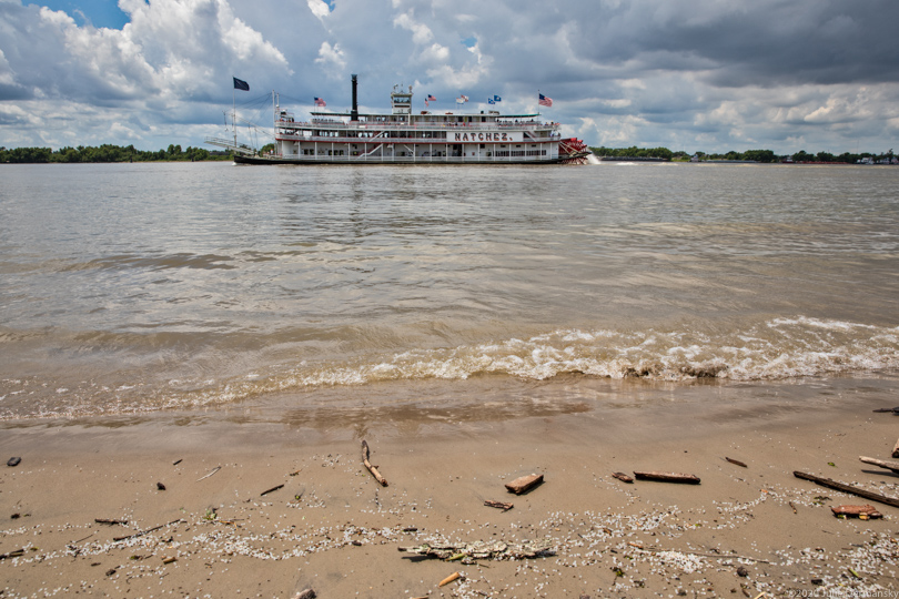Riverboat on the Mississippi River passing spilled nurdles in Chalmette, Louisiana