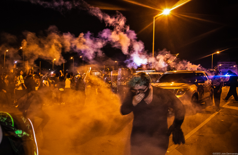 June 3 protesters flee from a police line that fired tear gas and projectiles