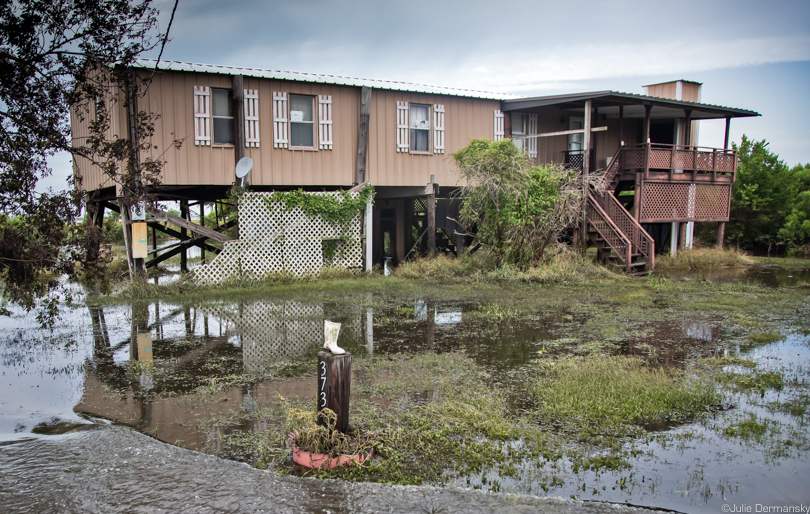 Floodwaters receding from a raised home on Isle de Jean Charles