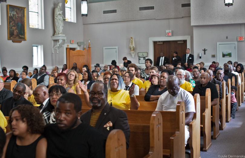 Members of the Coalition Against Death Alley wearing yellow RISE St. James t-shirts at Mayho's funeral.