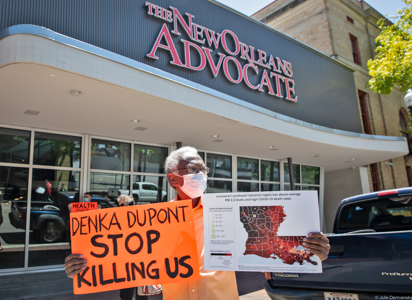 Robert Taylor holding a sign in protest outside The New Orleans Advocate office