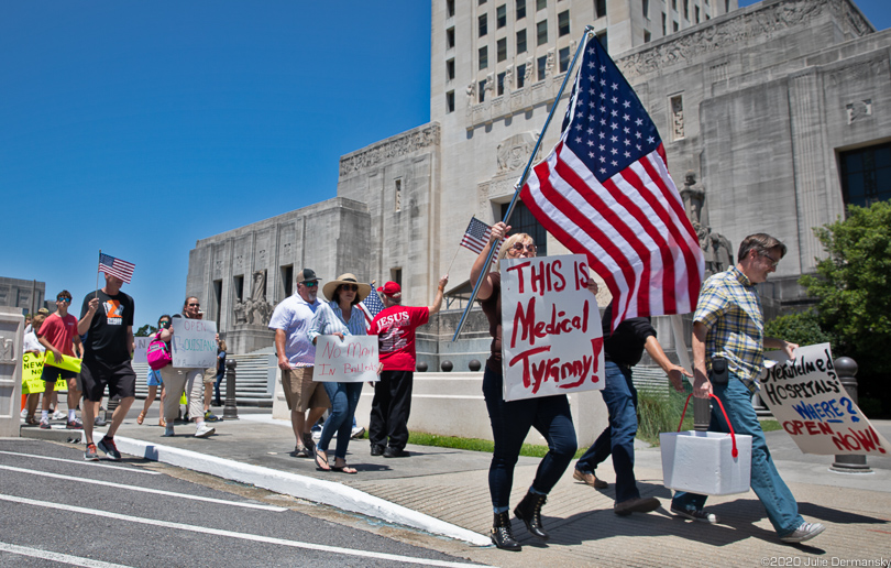 Protesters at an “End the Shutdown" event in Baton Rouge on April 25 march from the Capital Building to the Governor’s Mansion nearby. 