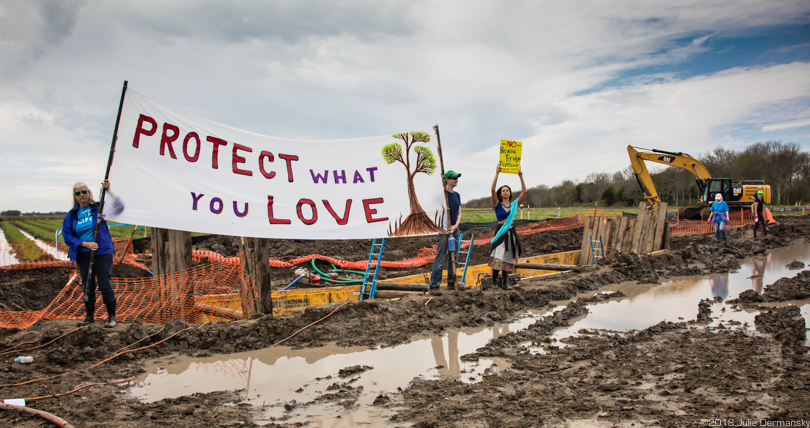 Protesters display a banner at a Bayou Bridge pipeline construction site in Louisiana