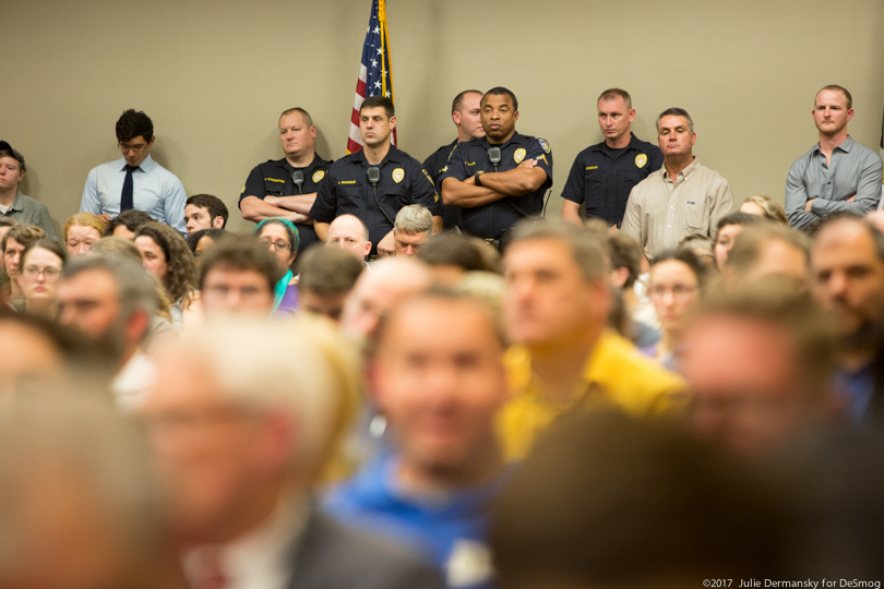 Law enforcement officers stand at the back of a packed room that turned out for a Bayou Bridge pipeline permit hearing