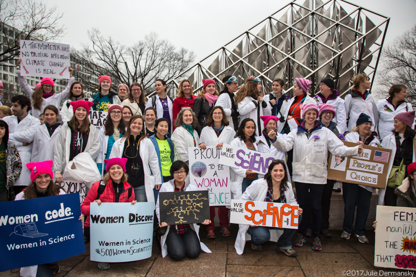 Group of mostly women scientists posing together with their pro-science signs before the march.