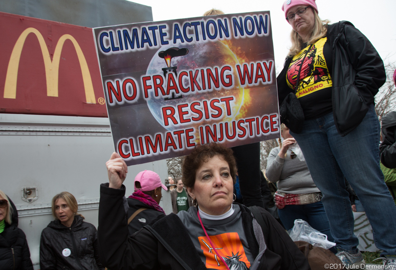 A woman holds an anti-fracking sign at the Women's March.