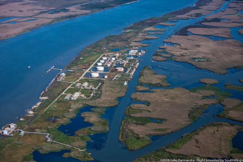 Oil and gas industry storage tanks and processing facilities at the mouth of the Mississippi River.