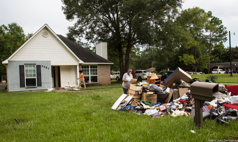 Tam Williams and her family clearing items from their flooded home in Louisiana