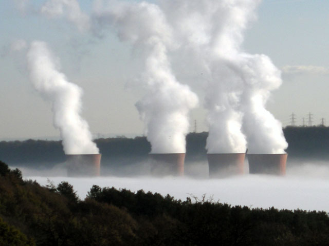 Steam rising from cooling towers in coal plant
