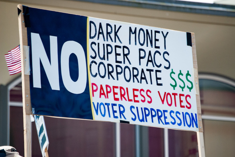 A parade in Everett, Washington, in 2017 features an anti-dark money sign