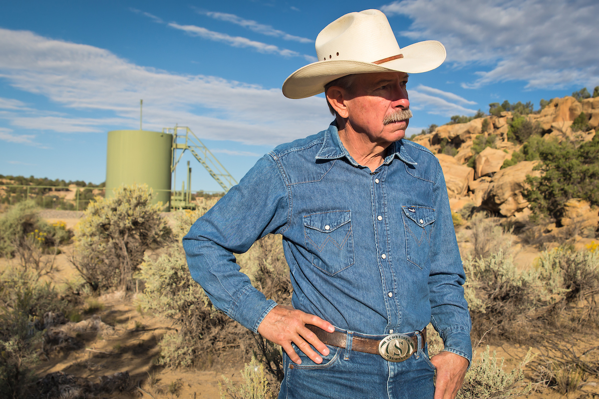 Don Schreiber on his ranch in Blanco, New Mexico, in front of a gas well re-drilled in 2014 on Bureau of Land Management land he leases.