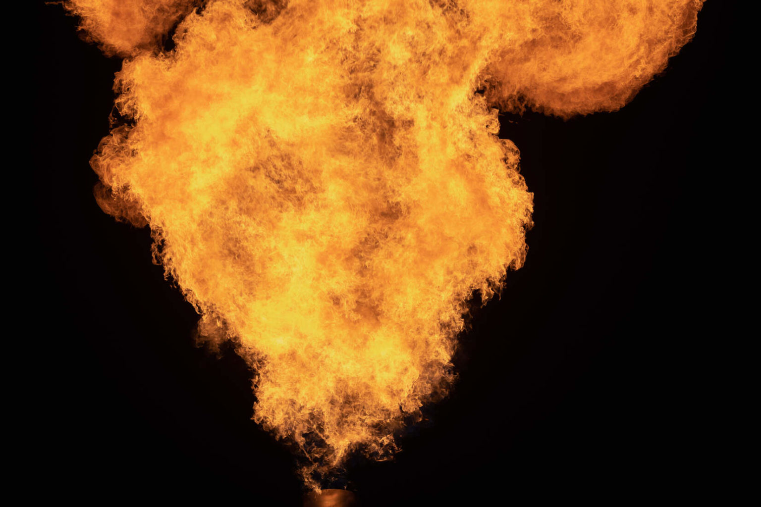 A large orange fiery flare of methane gas.
