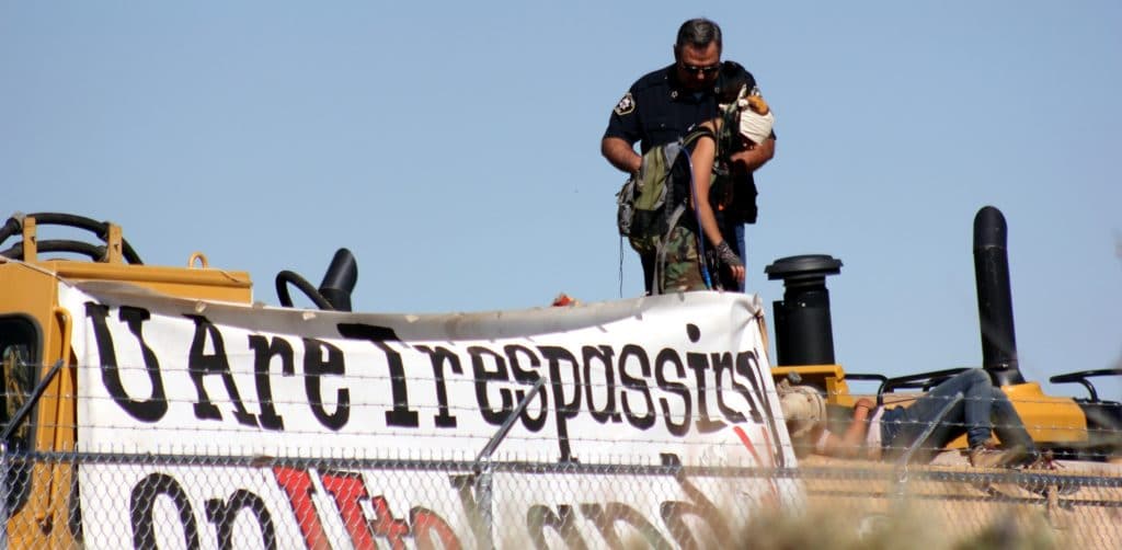 Parts of U.S. Oil Sands mine site extend onto Ute tribal lands. The Environmental Protection Agency warned the company in June that it didn't have permission to operate on Ute land. On July 21, 2014, fifteen people chained themselves to a fence and to machinery on the tar sands mine site operated by U.S. Oil Sands.