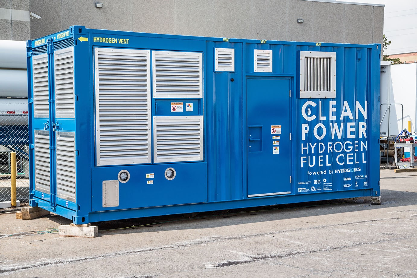 Large blue rectangular container with the words 'clean power hydrogen fuel cell' in white text on it