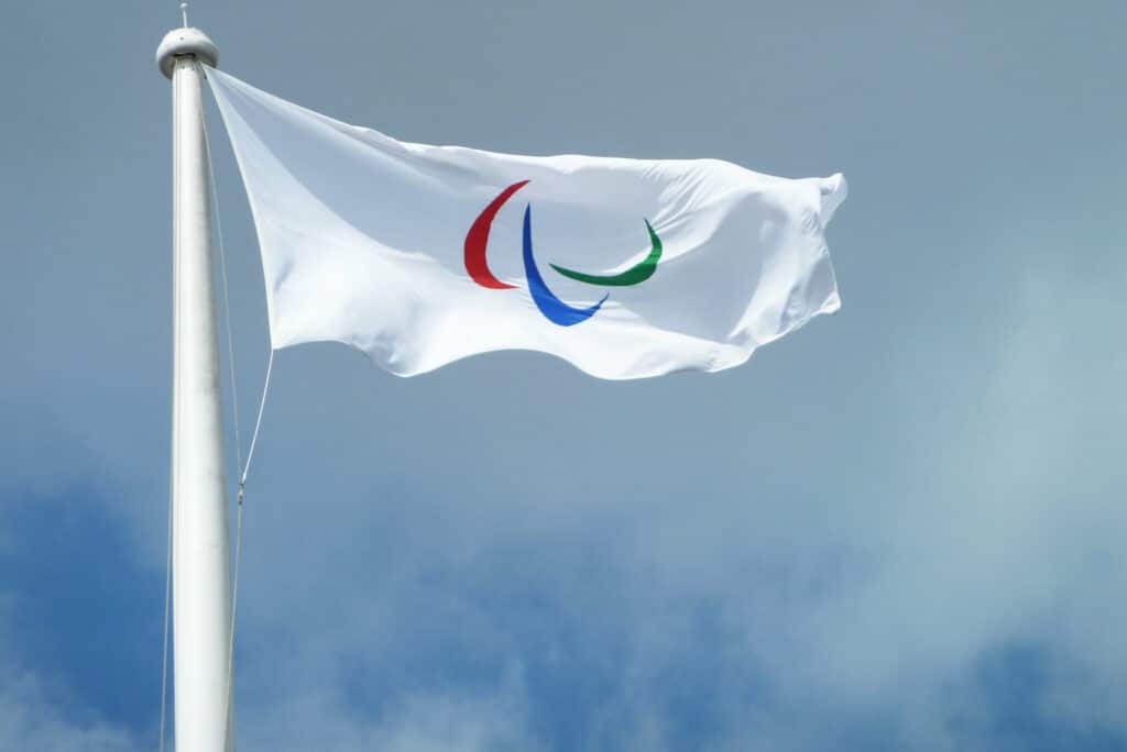 A white flag with red, blue, and green arcs