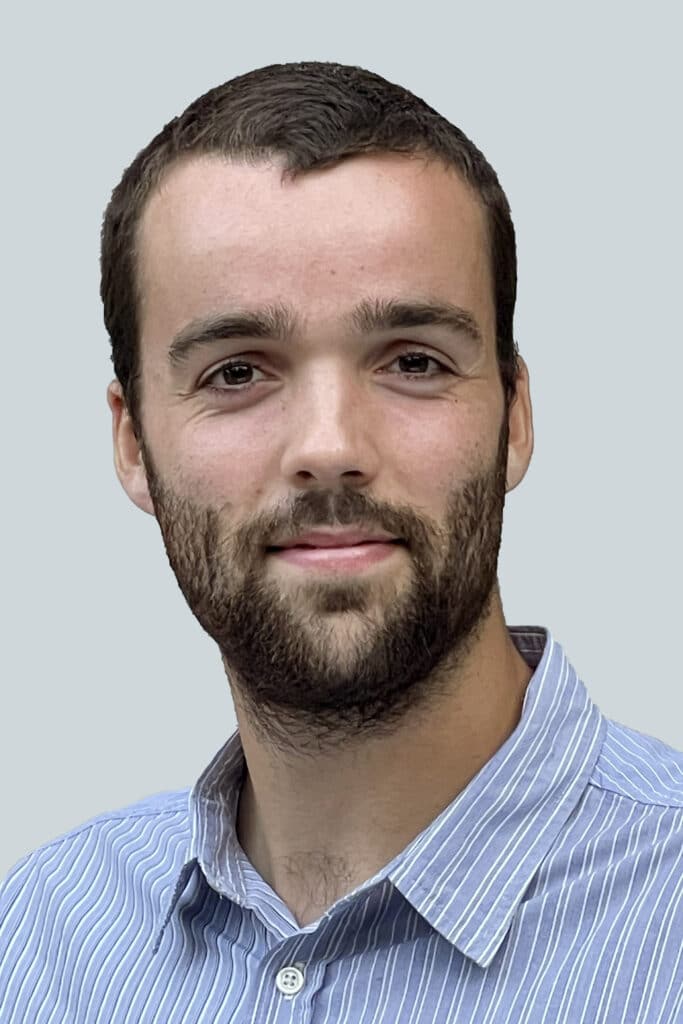 A white man with thin-cropped dark brown hair and beard