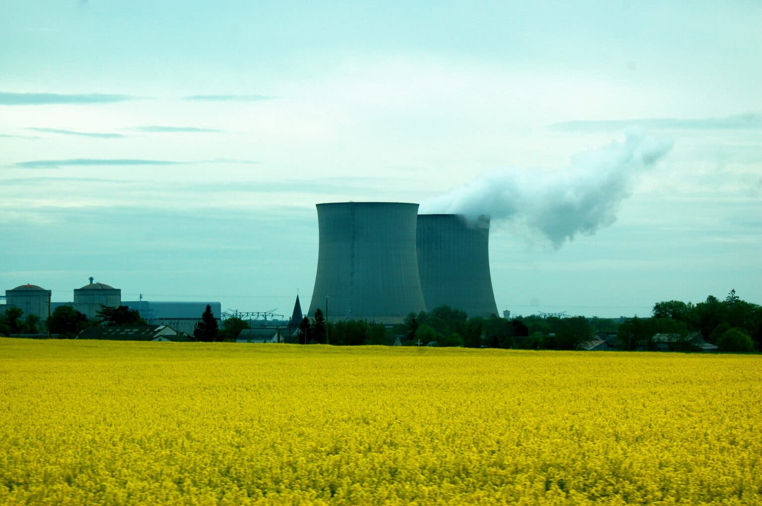 A nuclear power plant is surrounded by a field of yellow mustard flowers outside Paris, France.