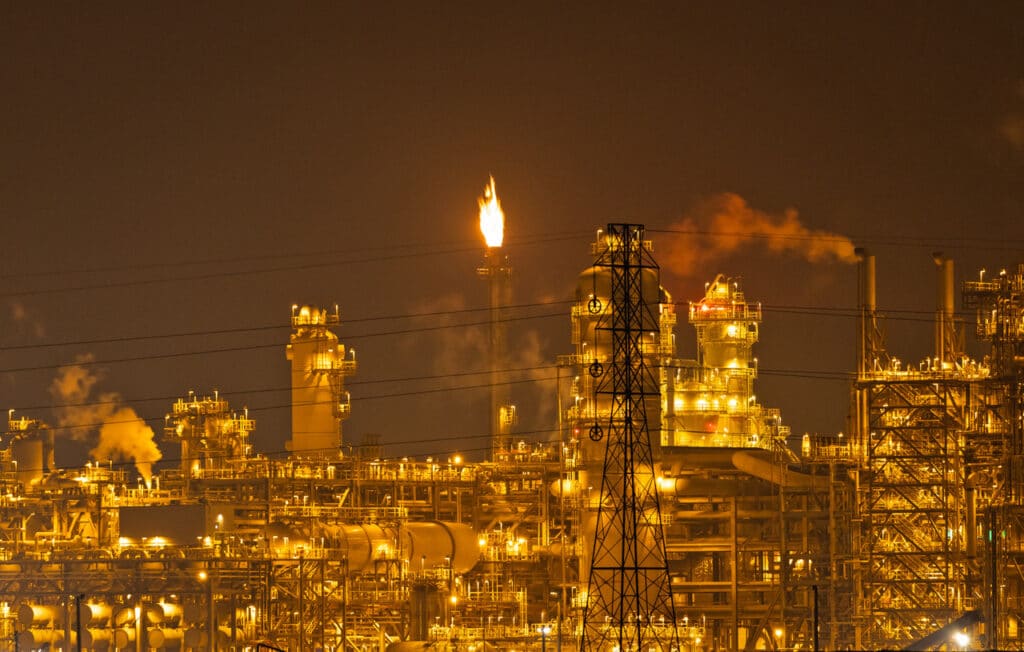 A tower flares at night at a petrochemical plant along the Gulf Coast of Texas.