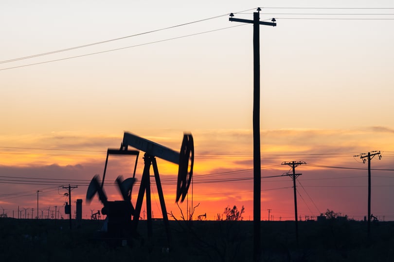 Pump jacks silhouetted against the sunset in Ector County, Texas.