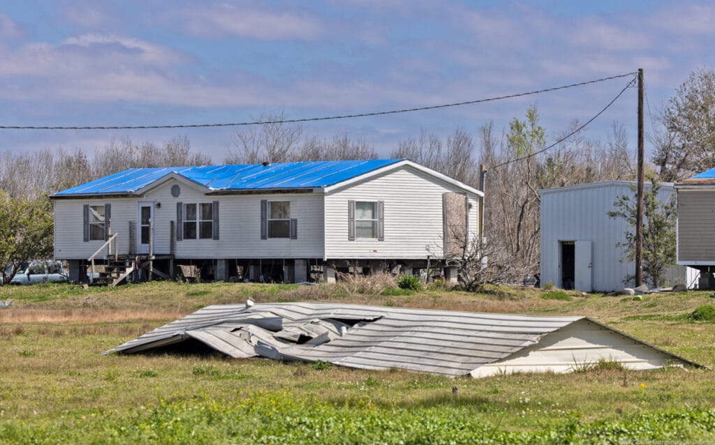 Home with tarped roof in Chauvin, LA, on March 4, 2022. Credit: Julie Dermansky.