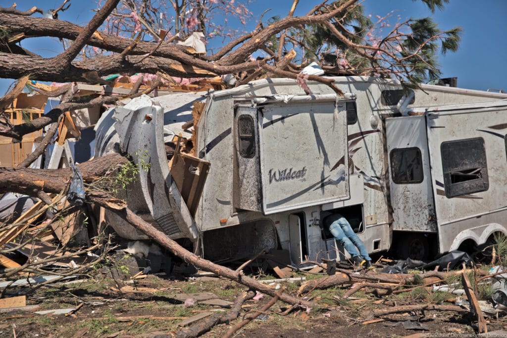 Chad Lestelle getting his belongings from a camper trailer crushed by a tree.