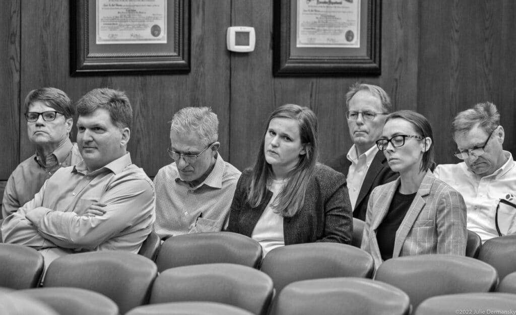 Industry lobbyist listening and taking note at the permit hearing.