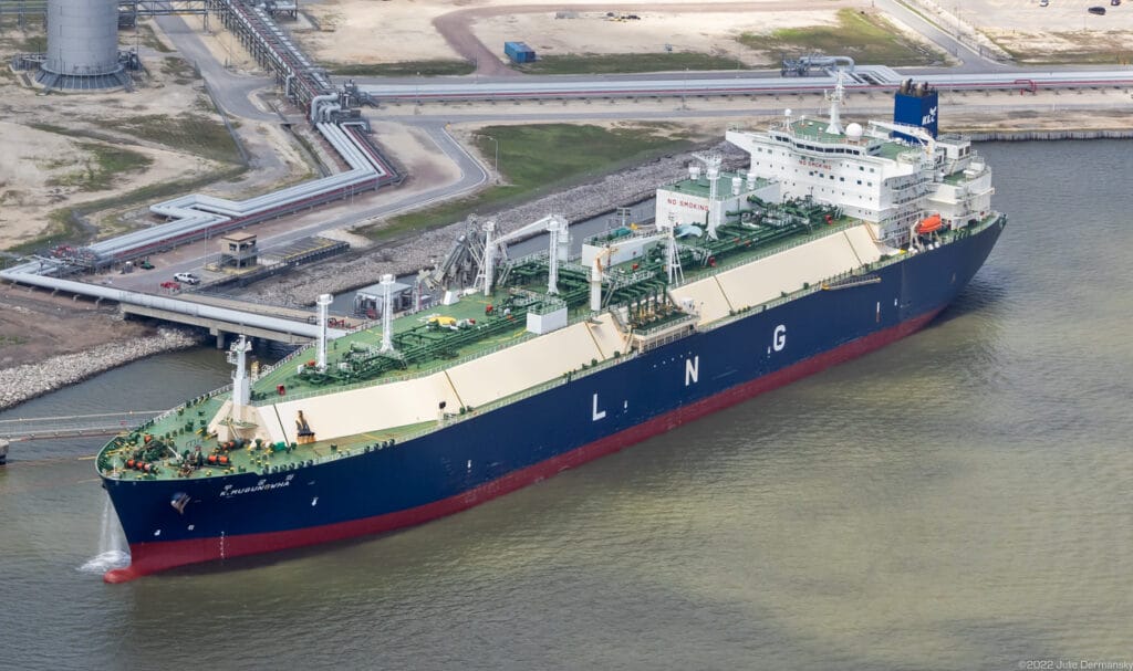 Large liquefied natural gas tanker ship docked at an LNG export terminal in Louisiana