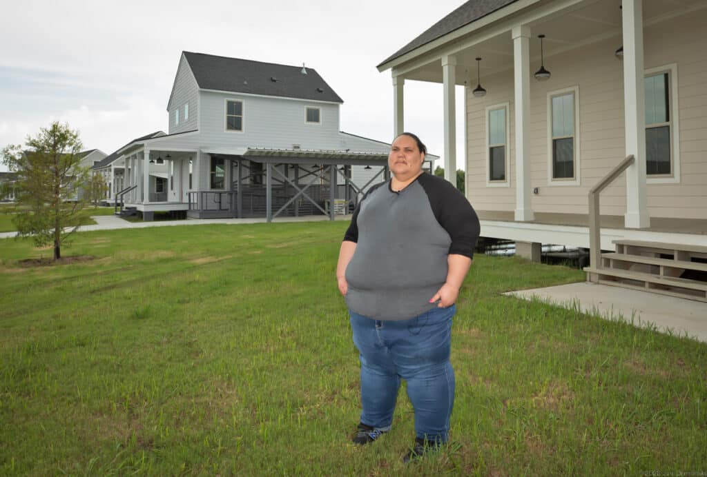 Chantel Comardelle at “The New Island” site on August 5, the day after the first move-in date was cancelled, checking out the standing water issue under the new homes.