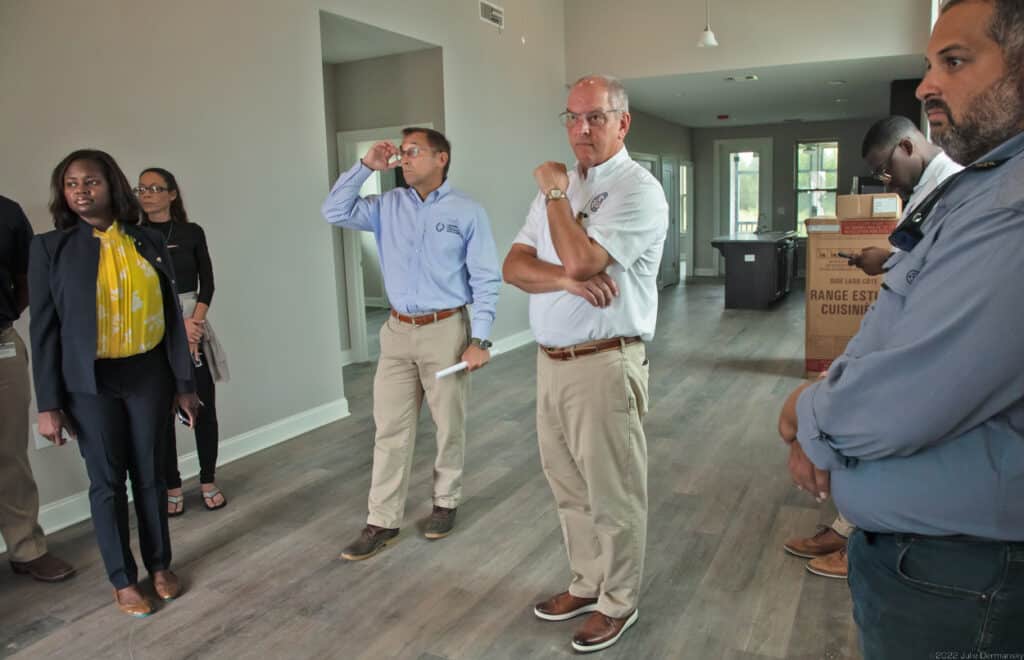 Gov. John Bel Edwards with Pat Forbes in one of “The New Island” homes