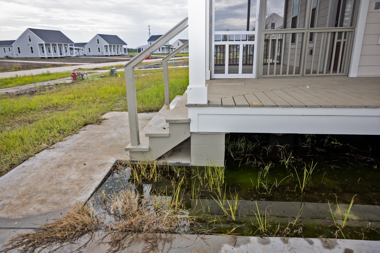 Water under houses at the New Isle