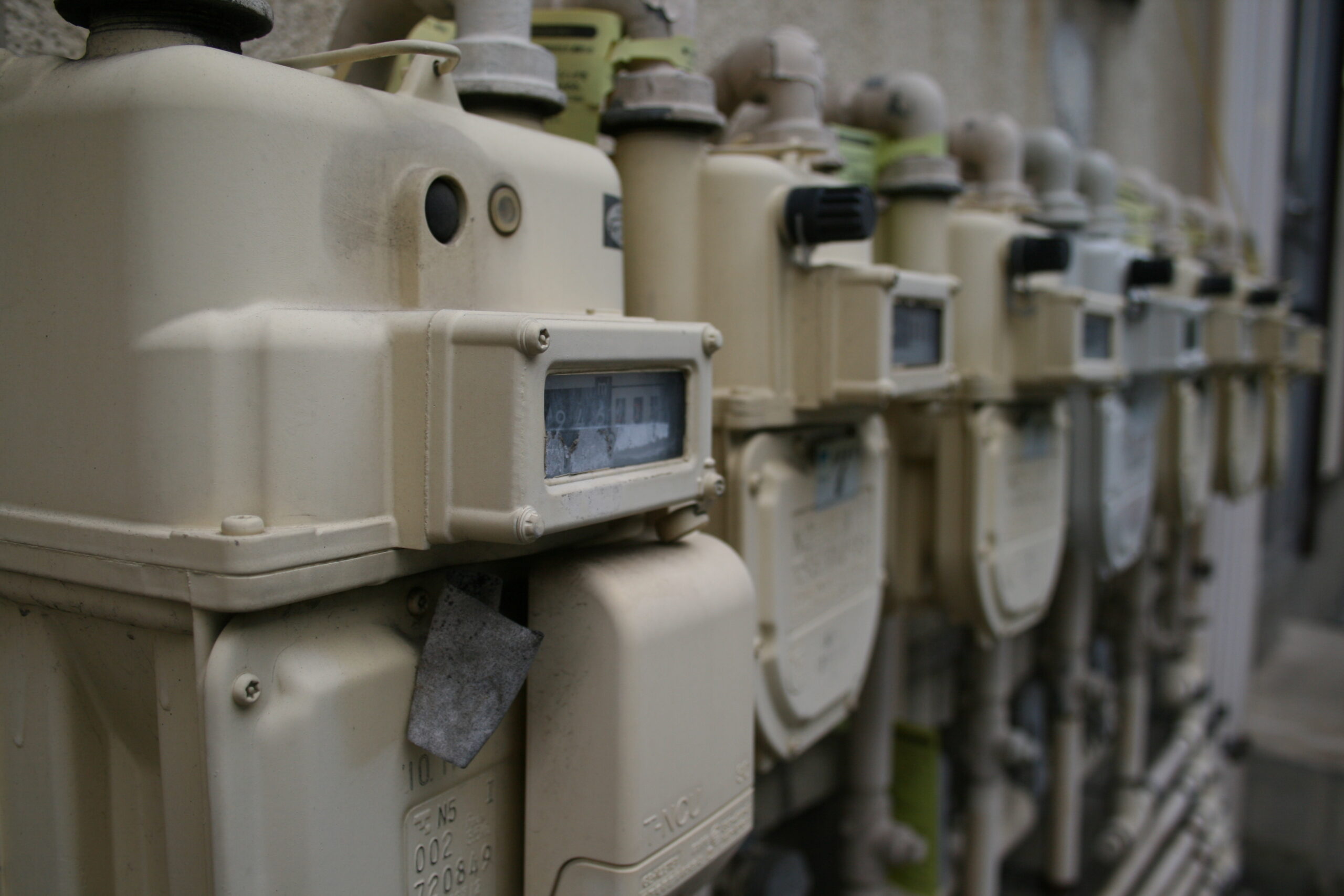 a row of gas meters on a wall