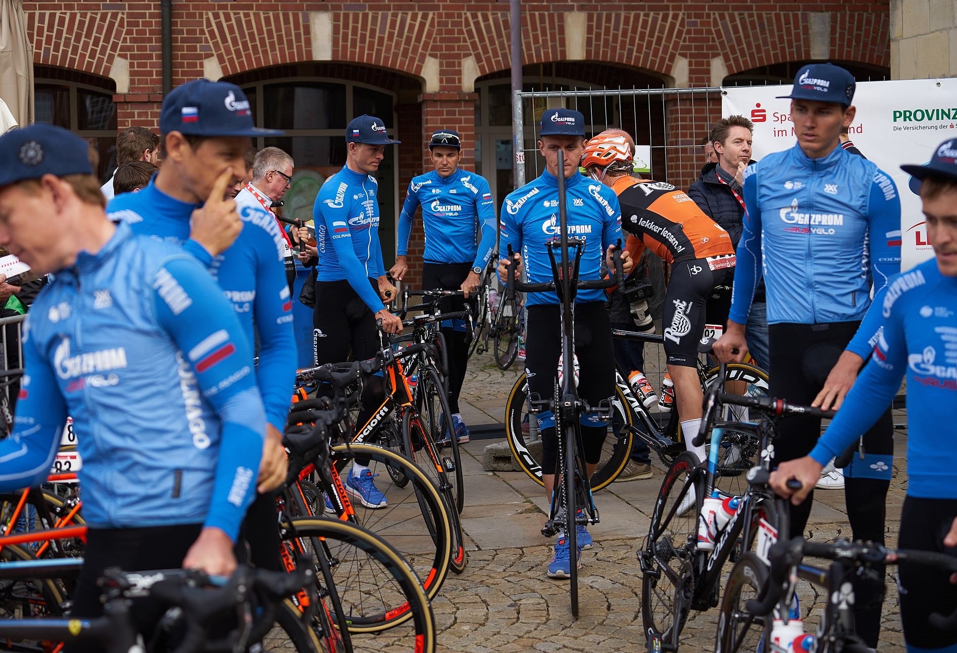 the Gazprom-sponsored cycling team, all men in blue jerseys with bikes