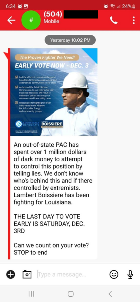 Mobile phone text message asking voters to vote for Lambert Boissiere, shown in a hard hat looking left at a solar panel.