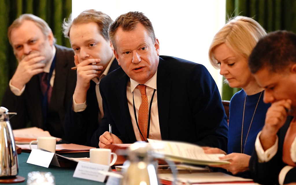 a group of British politicians sit around a table