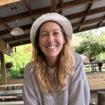 Sara Sneath sitting under a picnic shelter