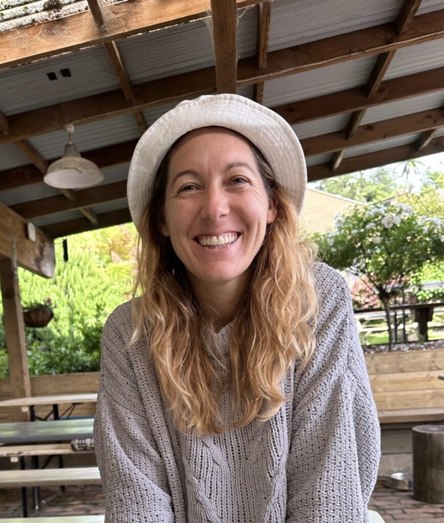 Sara Sneath sitting under a picnic shelter