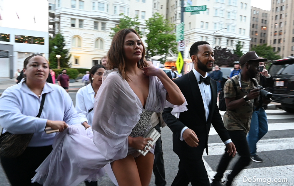 John Legend and Chrissy Teigen rushed in wearing formal attire, followed by assistants, from the street.