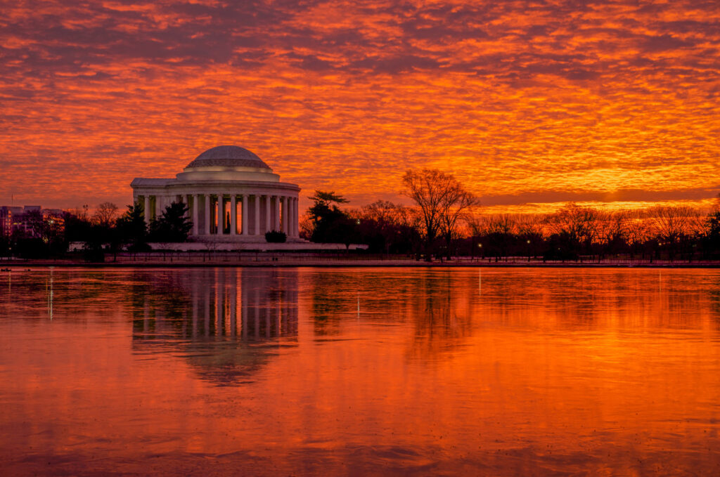 Fiery sunrise over the Tidal Basin in Washington, D.C., with the Jefferson Memorial on the far shore.
