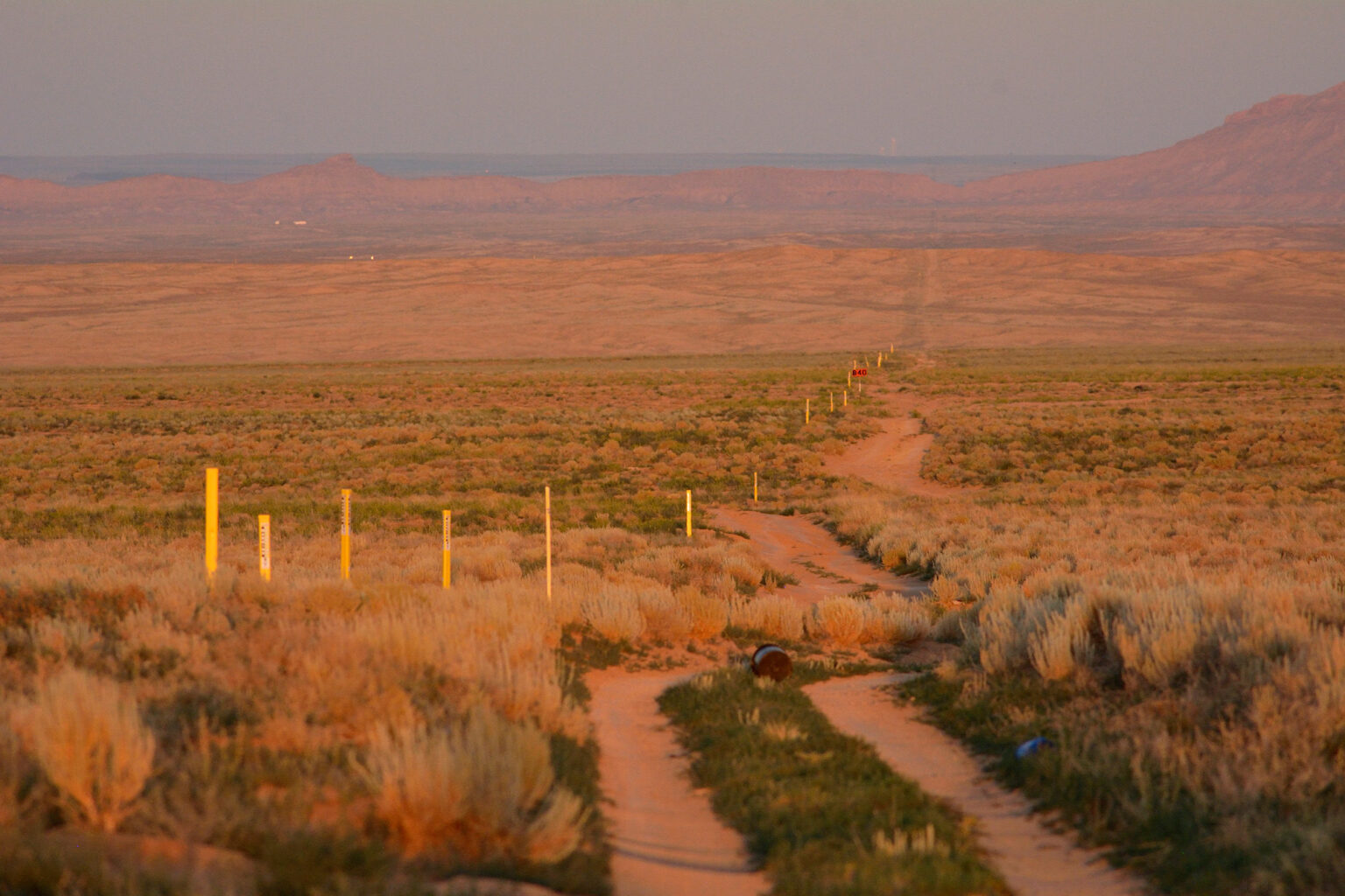 Dusk falls on the existing Southern Trails natural gas pipeline owned by the Navajo Nation as it passes through empty land west of Shiprock, New Mexico. Locals say someone showed up and put in the yellow markers a few months earlier.