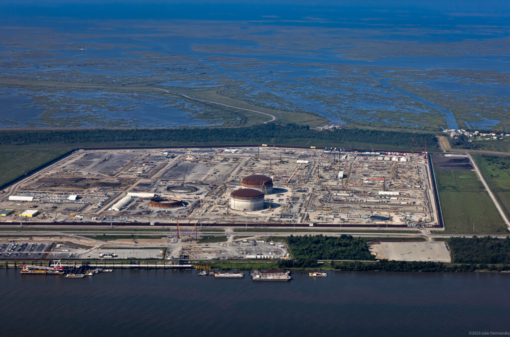 Aerial view of an industrial site adjacent to an extensive wetland.