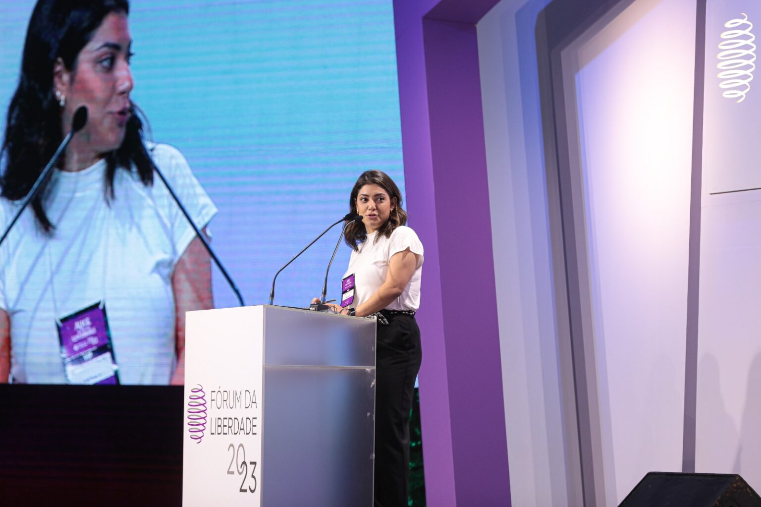 Camila Telles speaking from the stage at the 2023 Liberty Forum in Porto Alegre, Brazil.