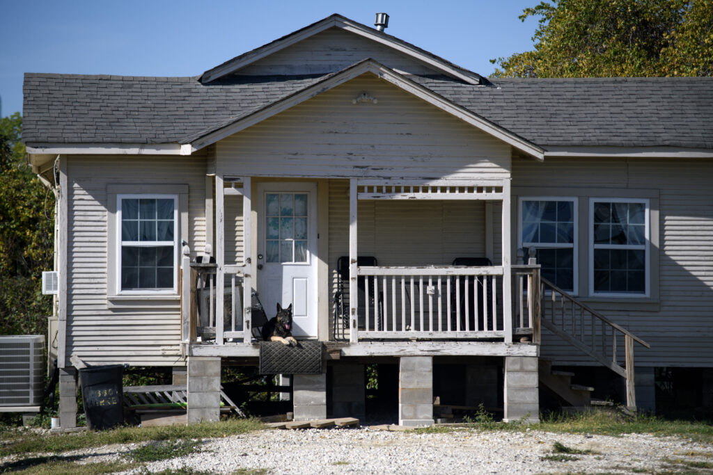 A dog sits on its porch in Channelview, TX, U.S., on Wednesday, December 6, 2023. 

Photographer: Mark Felix/Public Health Watch