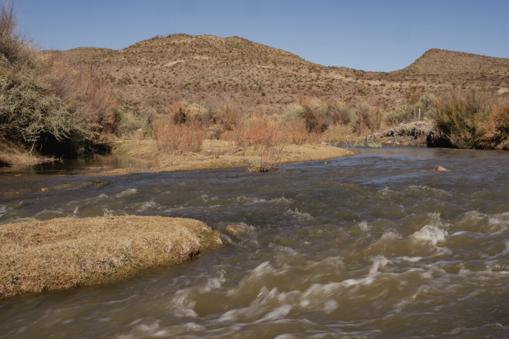 An undisturbed portion of the Rio Grande winds through dry brush and hills of west Texas.