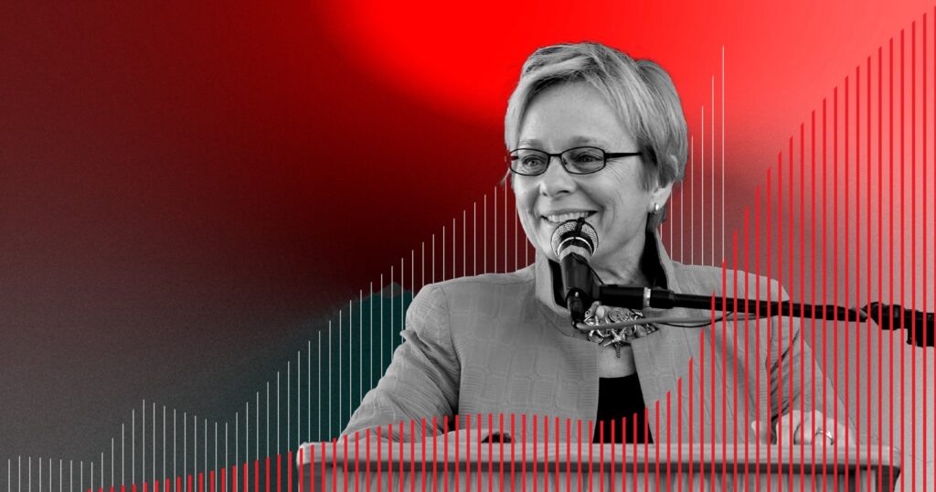 In this photo illustration, a photo of Susan Avery smiling at a podium is set amid bar charts and a red background