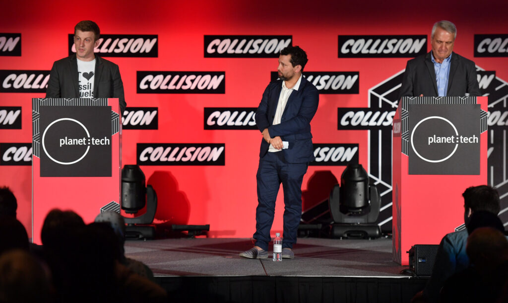 In 2017, Alex Epstein, Center for Industrial Progress, left, sports an "I <3 fossil fuels" shirt. Sasha Issenberg, journalist & author, center, and Bill Ritter, Jr., Center for the New Energy Economy at Colorado State University, during Collision 2017 in New Orleans, Louisiana.