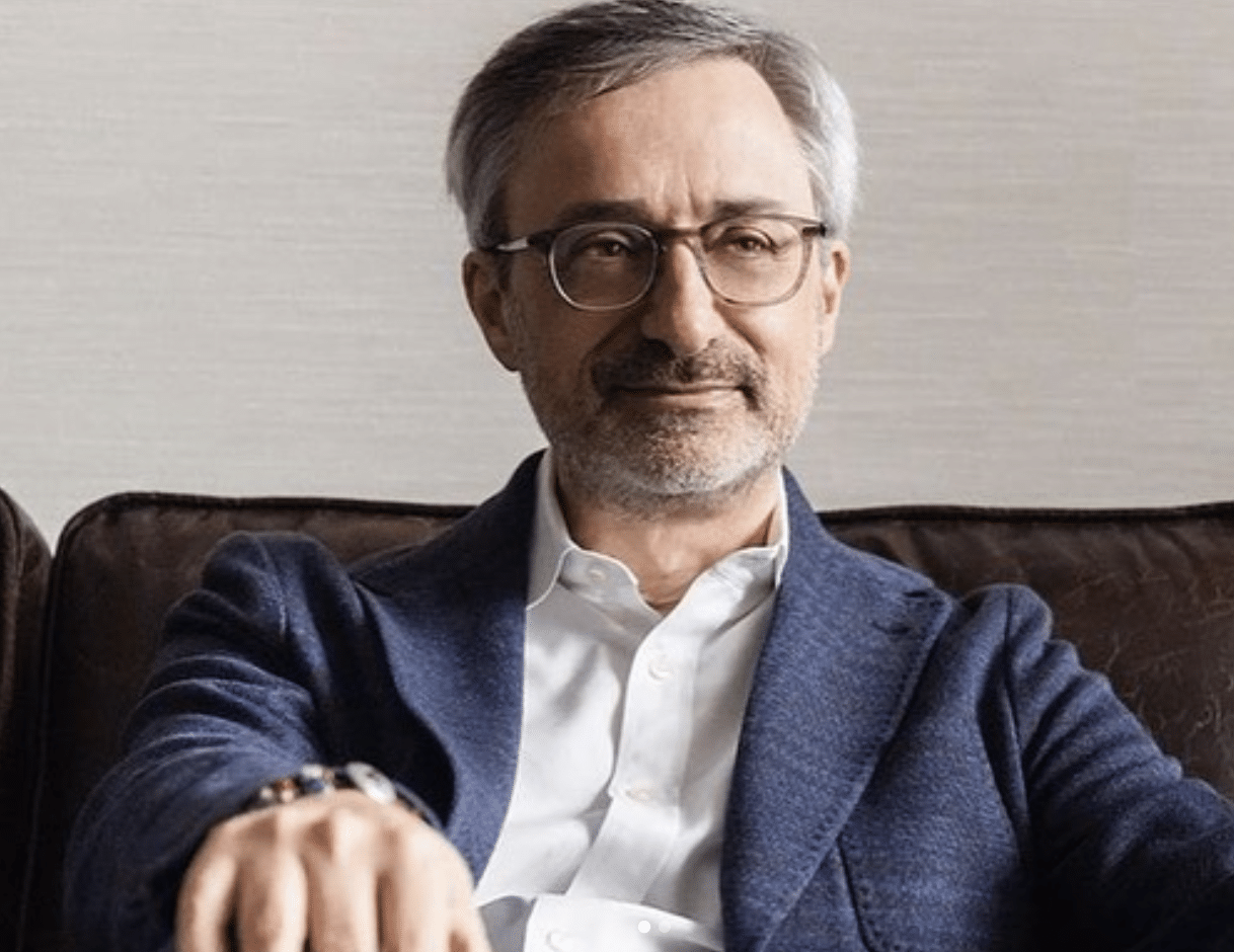 Photograph of Philippe Krakowsky, IPG CEO, in a white button-down shirt and a blue-on-blue plaid suit jacket.