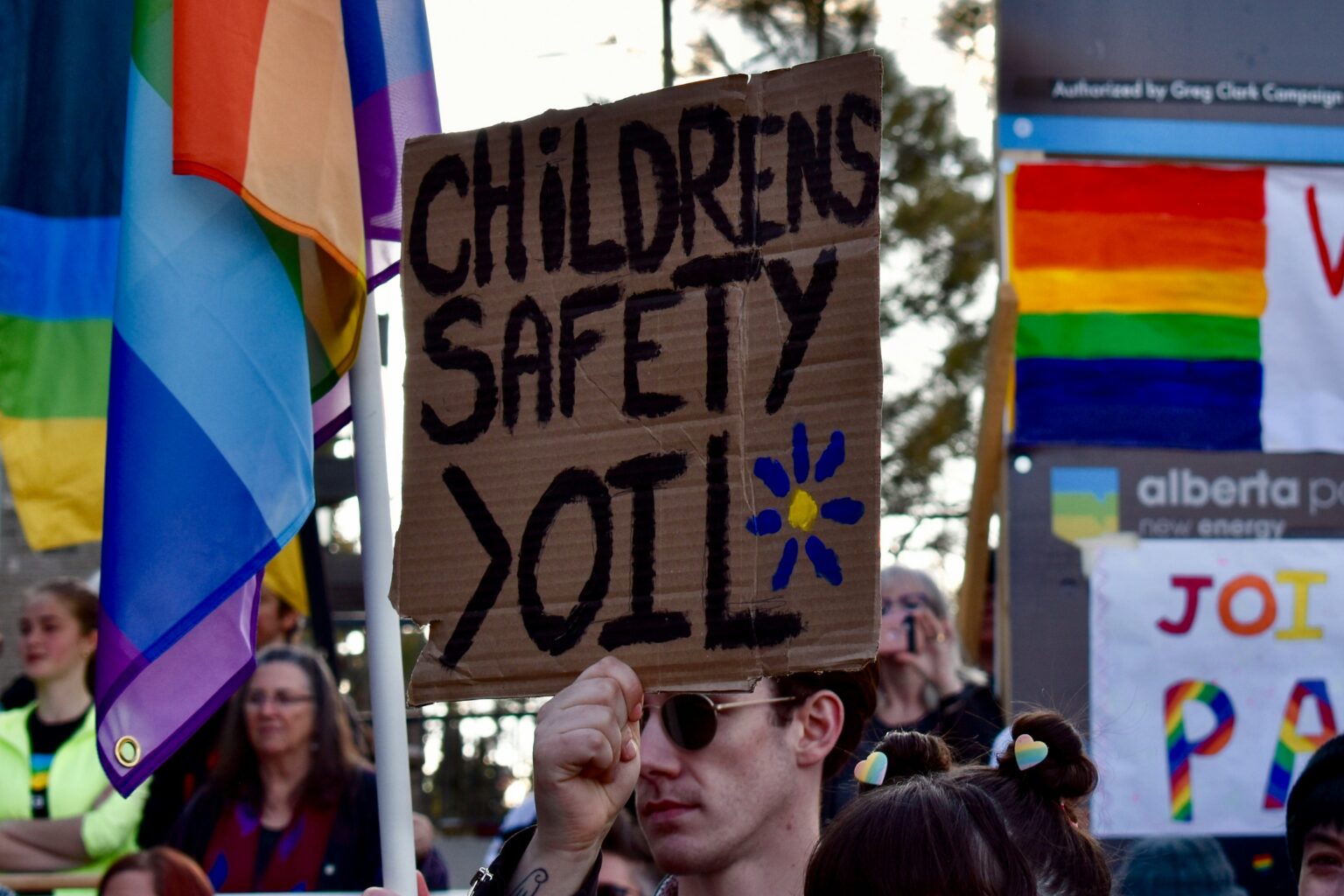 Protest sign reads "Children's Safety > Oil"